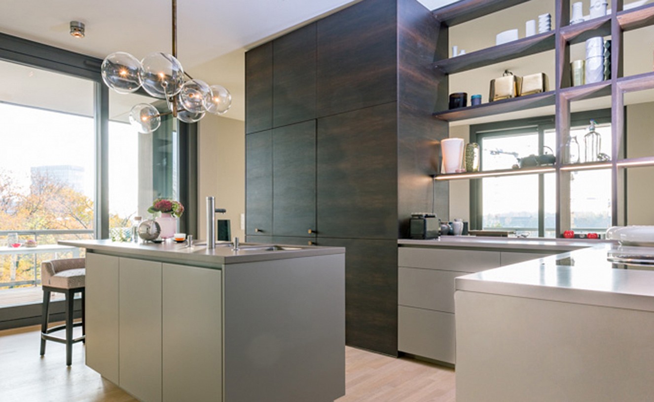 brillant interiors Interior Designer Berlin Mitte Private Rooms The kitchen builds the centre of the flat – a customized solution. Centerpiece is the room-high cupboard made of smoked oak, …